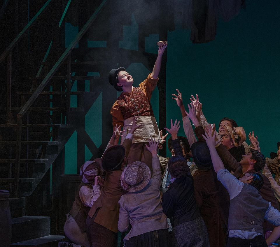 Actors hoisting someone up