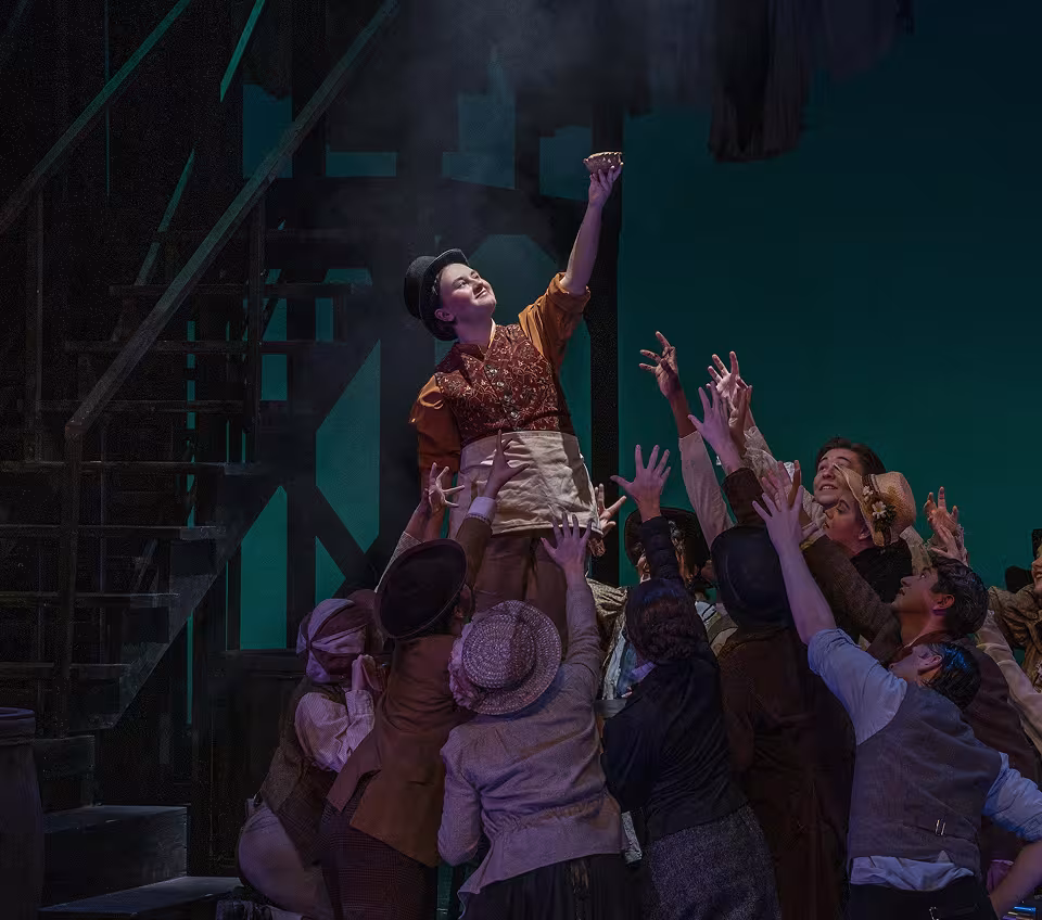 Actors hoisting someone up